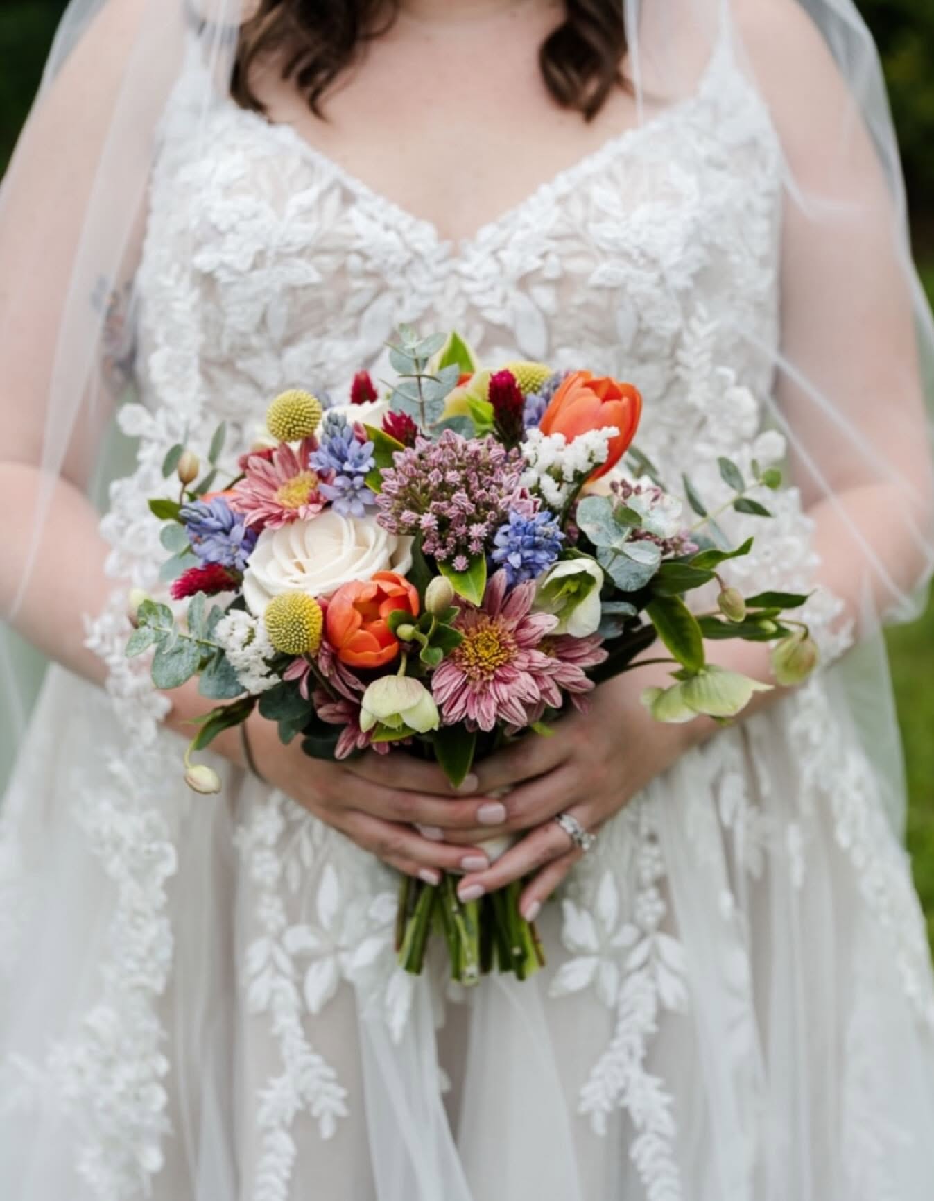 Bride holding a colorful wedding bouquet